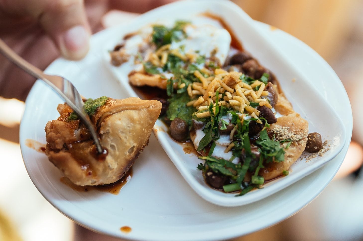 Papri Chaat is traditionally prepared using crisp fried dough wafers known as papri, along with boiled chick peas, boiled potatoes, yogurt and tamarind chutney and topped with chaat masala and sev.