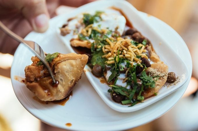Papri Chaat is traditionally prepared using crisp fried dough wafers known as papri, along with boiled chick peas, boiled potatoes, yogurt and tamarind chutney and topped with chaat masala and sev.