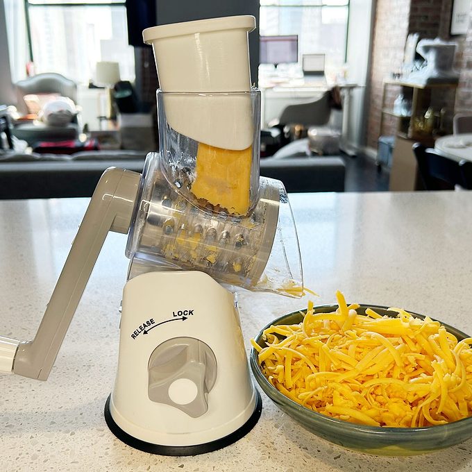 Viral cheese grater with the taste of home we tried logo in the upper right corner