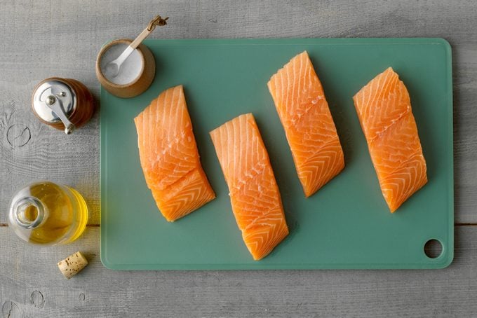 Overhead Shot Of All Ingredients for pan fried salmon On The gray wood surface