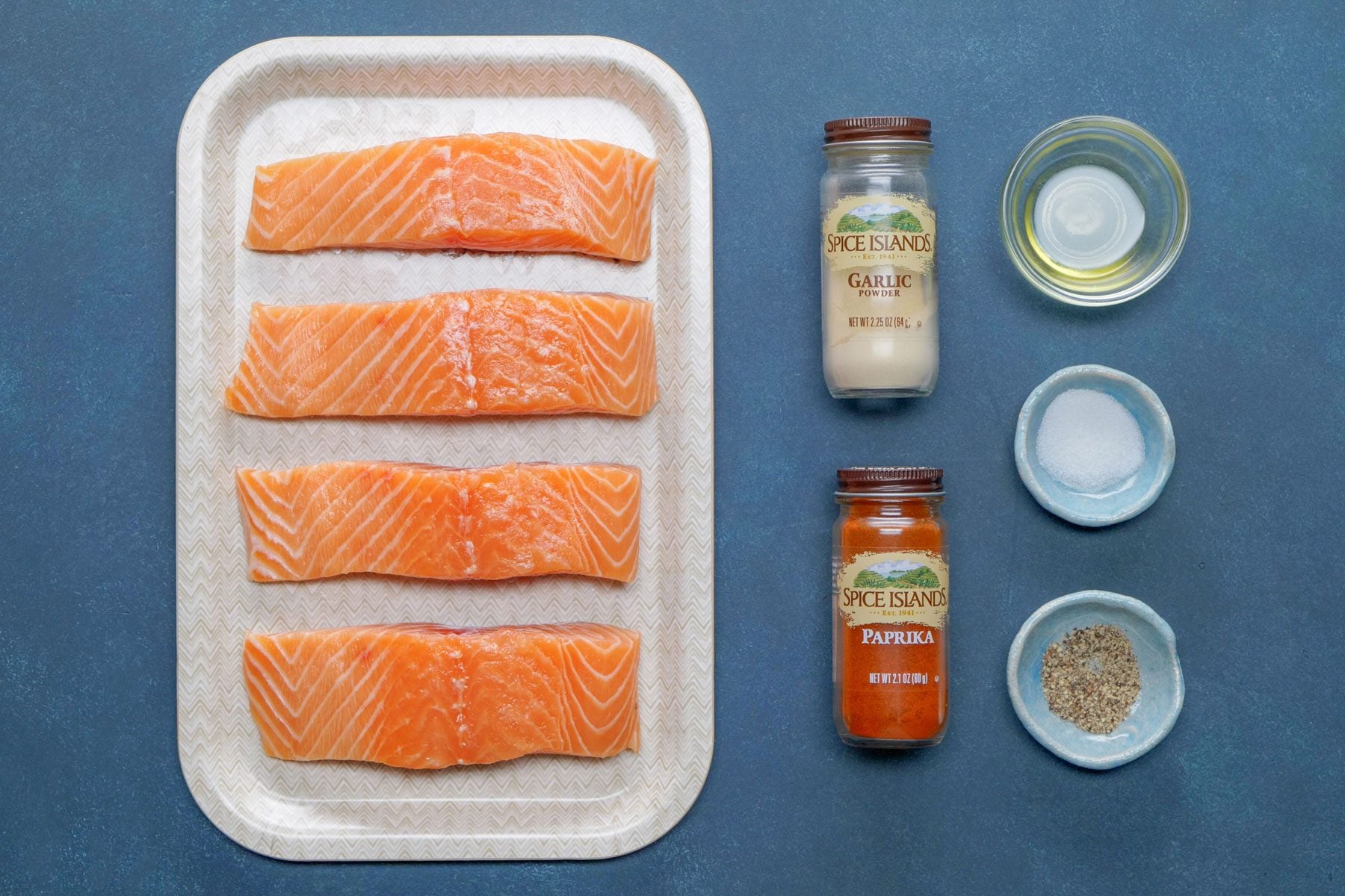 Olive oil, salmon and other seasoning on a table
