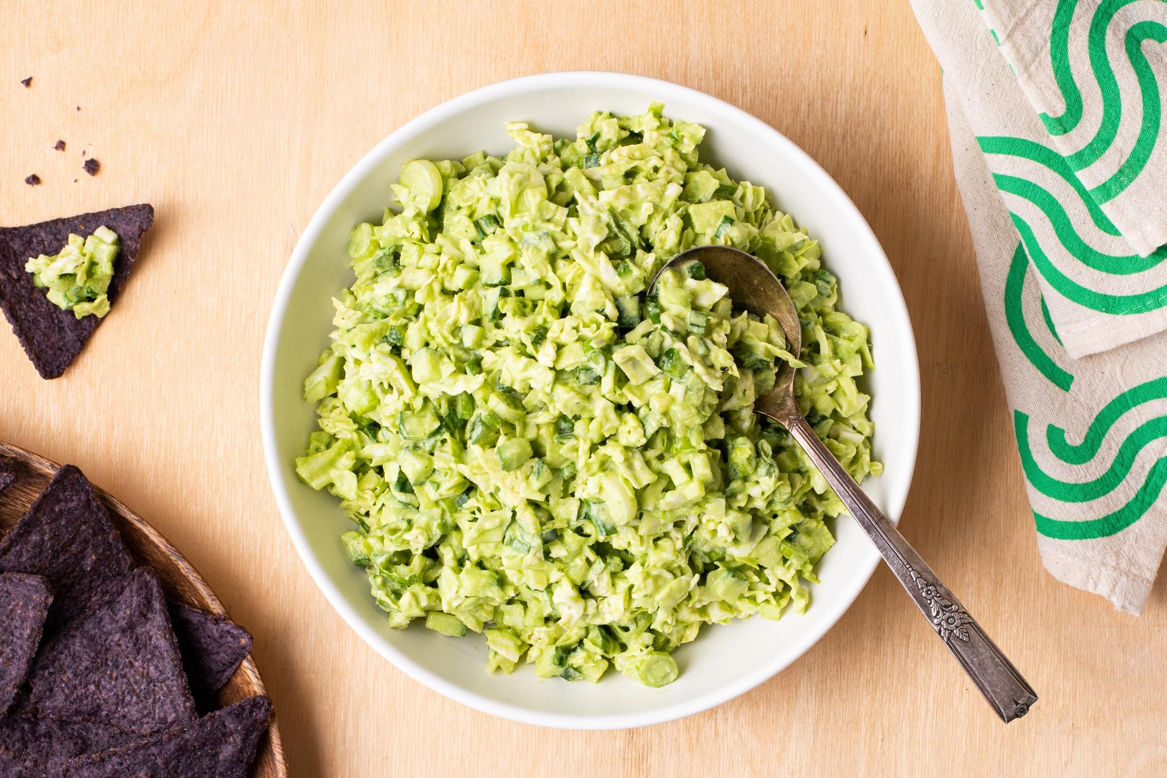 Green Goddess Salad I na white bowl with a side of tortilla chips