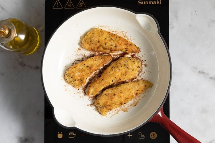 Frying chicken in pan