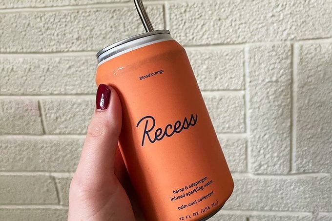 Blood Orange Recess Can flovor with a metal straw