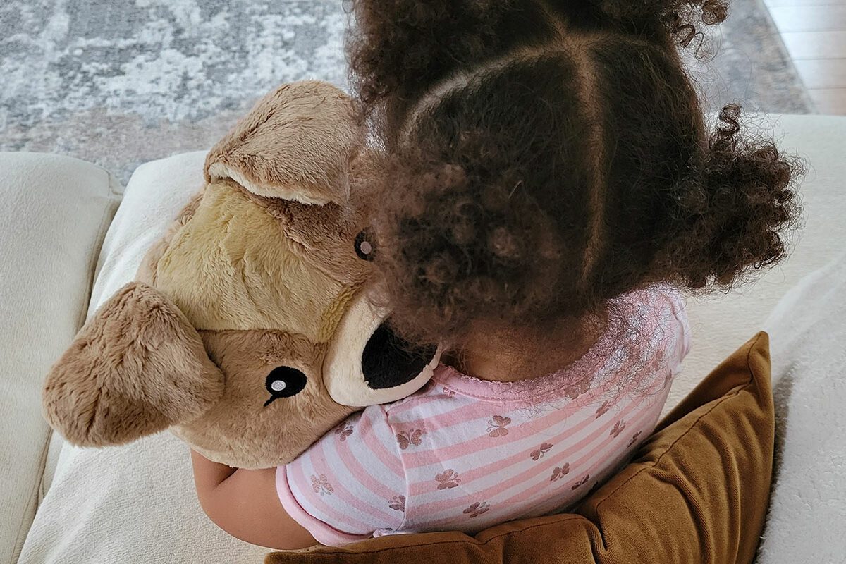 Girl holding stuffed animal