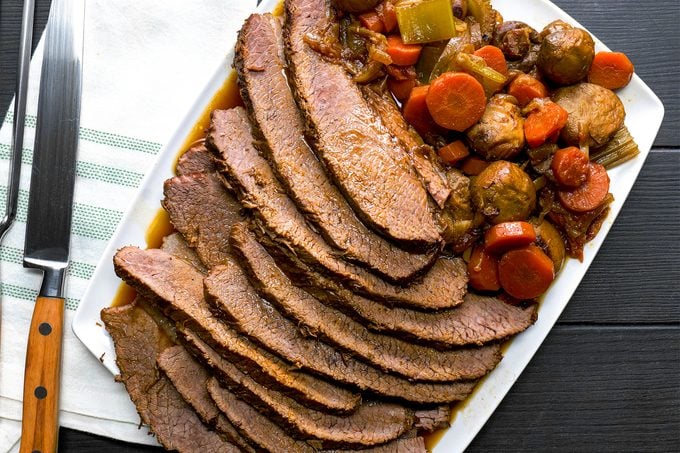 Braised Hanukkah Brisket with a knife next to the tray