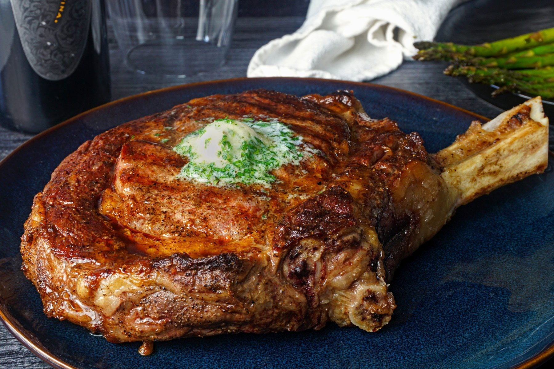 Prepared Cowboy Steak steak with a generous slice of ranch butter