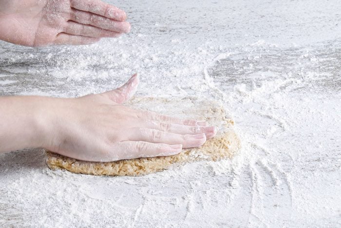 Flattening the dough on surface