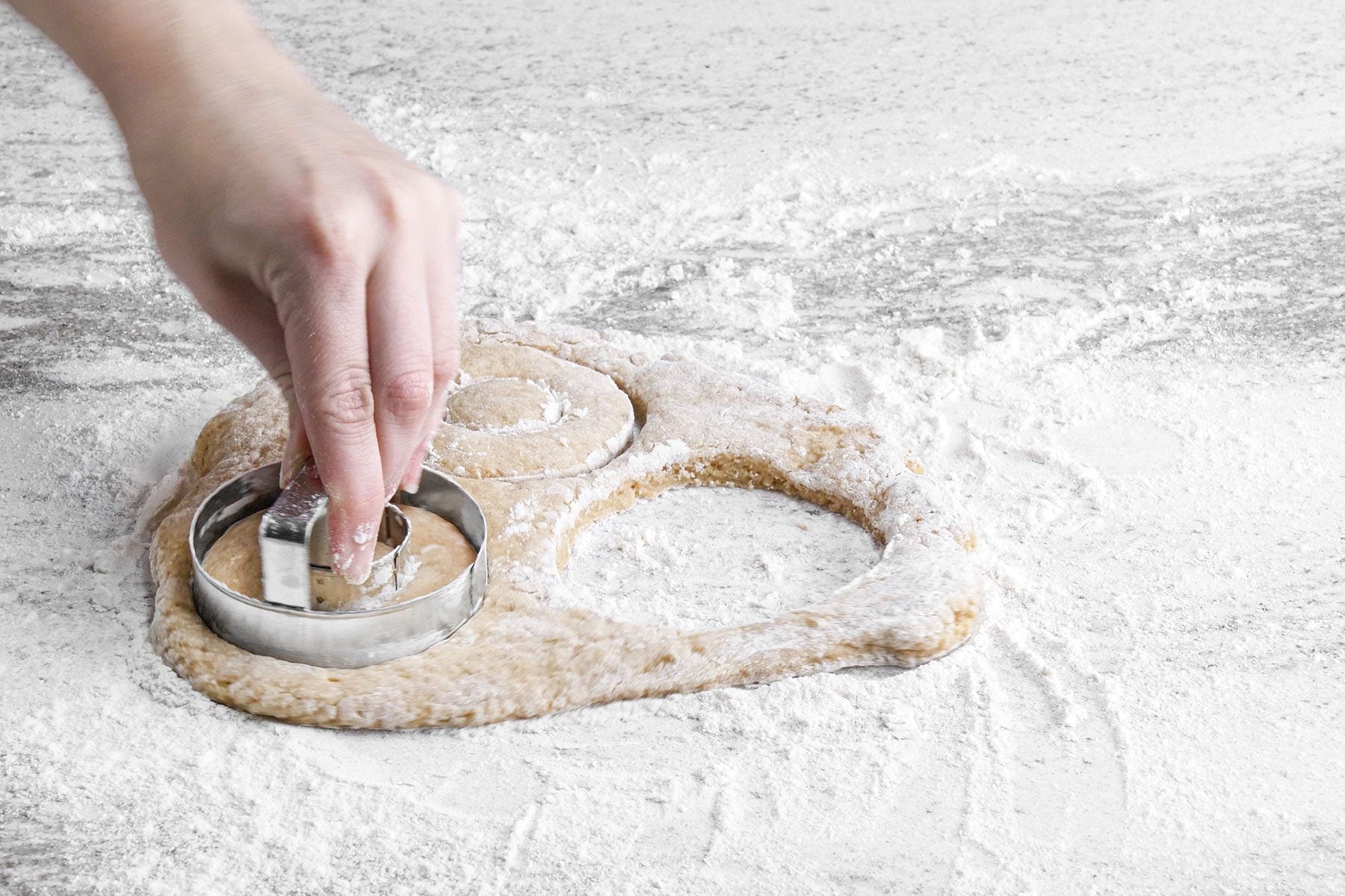 Cutting doughnuts with cutter 