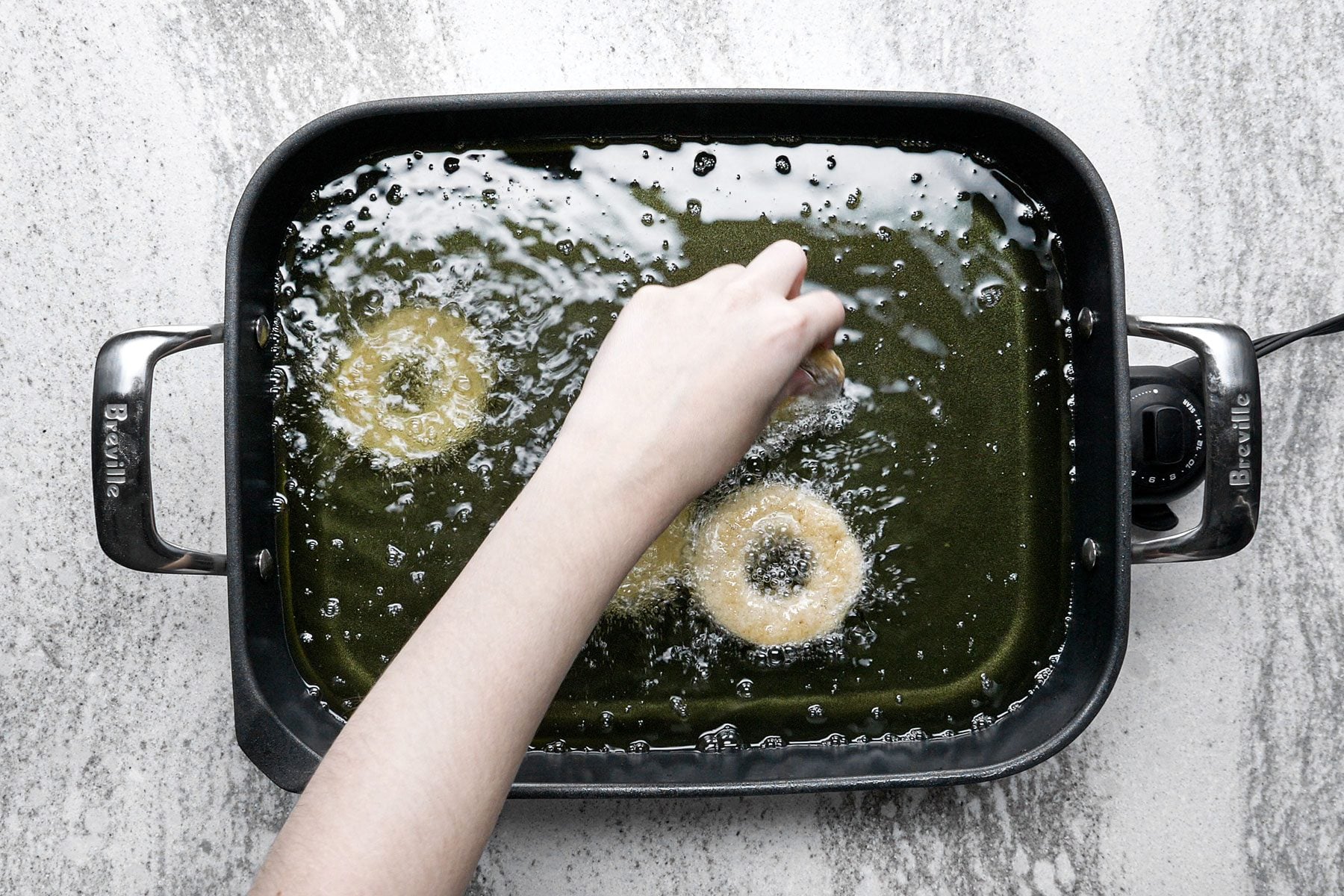 Frying the doughnuts in skillet