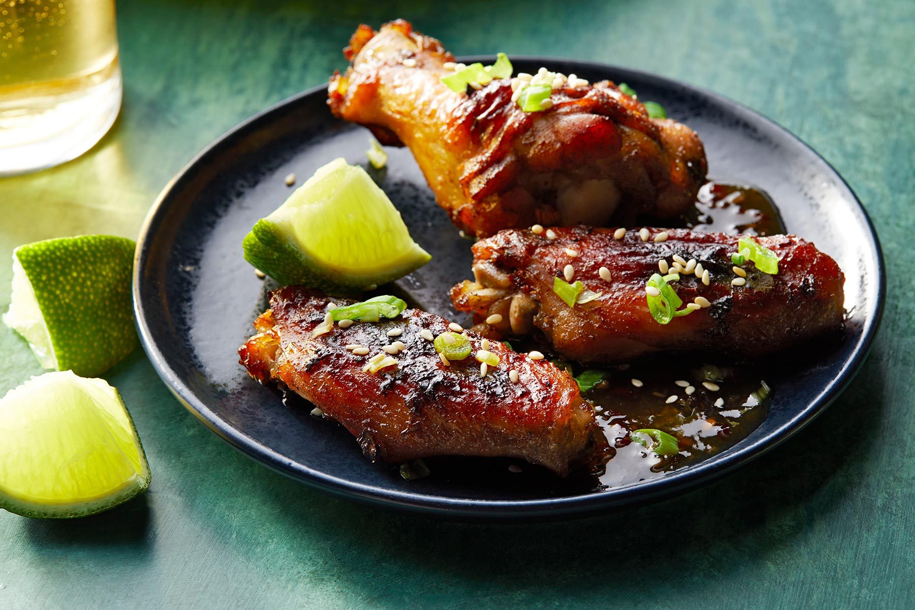 Asian Chicken Wings served on plate with lemon wedges