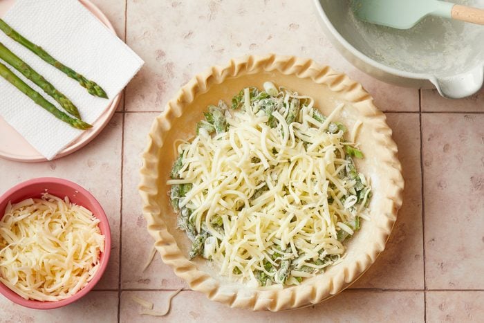 Cheese on Asparagus pie crust on a kitchen countertop