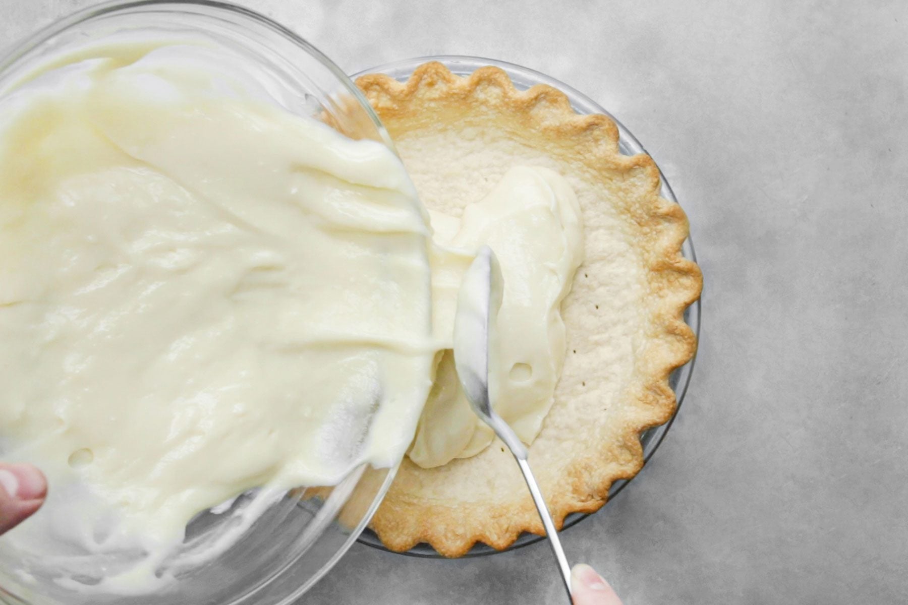 Spreading half the custard on pie crust