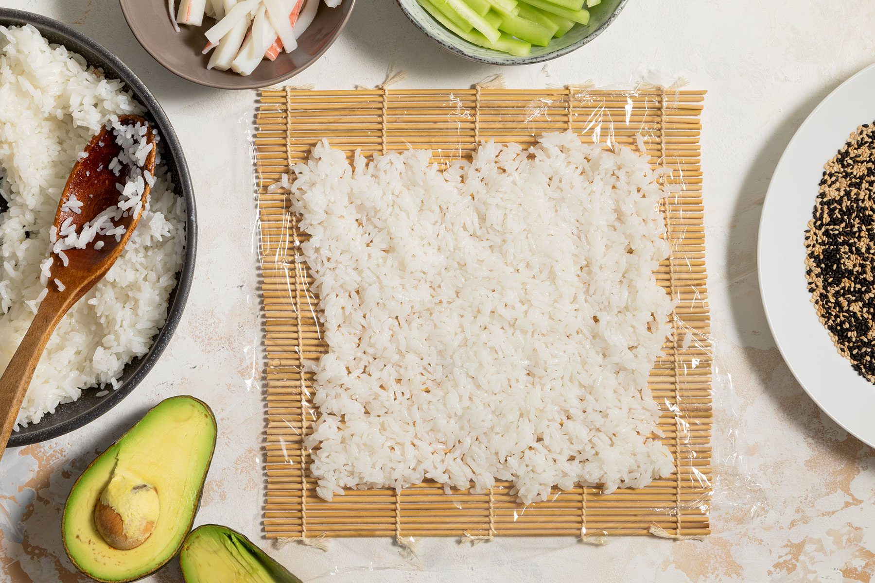 Rice shaped on sushi mat