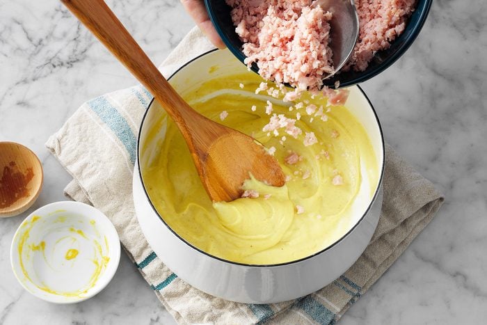 Adding grated ham in sauce
