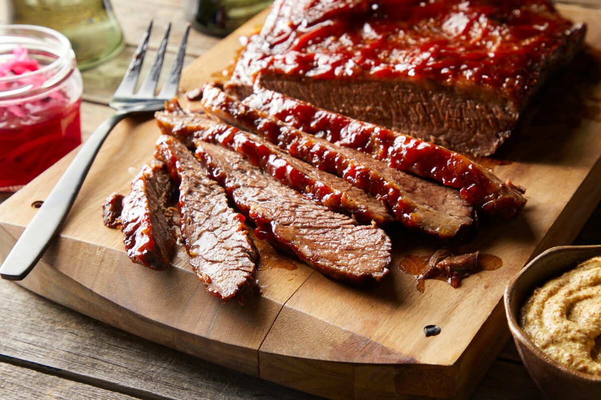 close up of sliced beef brisket on a chopping board