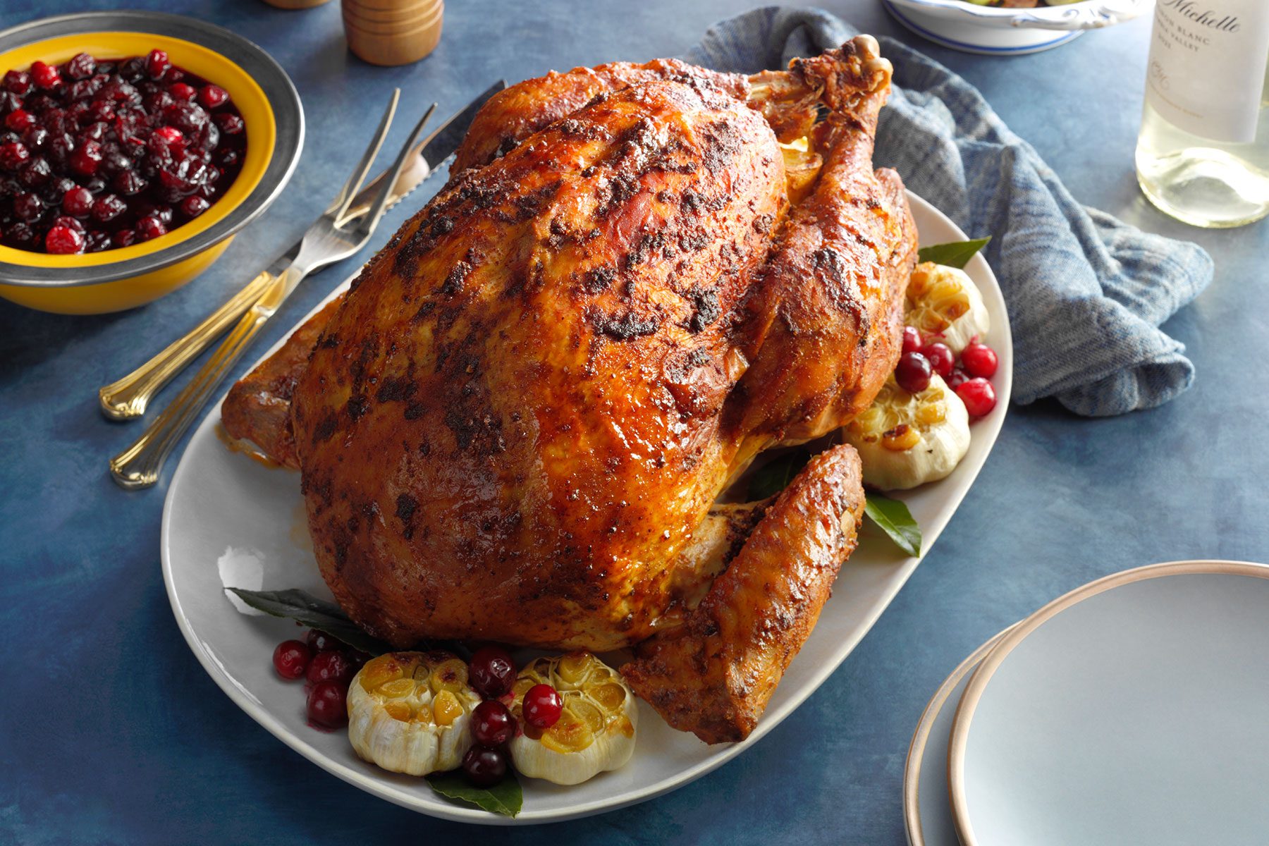 Seasoned Roast Turkey served on platter with garlic and cranberries