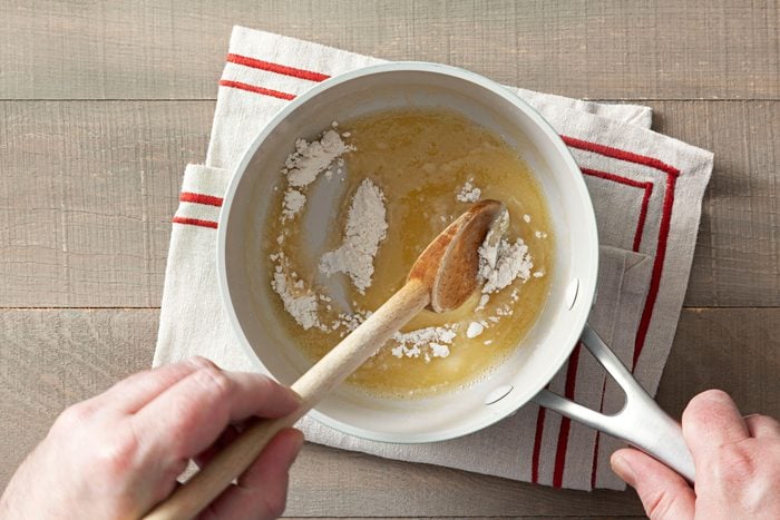 Mixing flour and butter in a large pan with a spatula