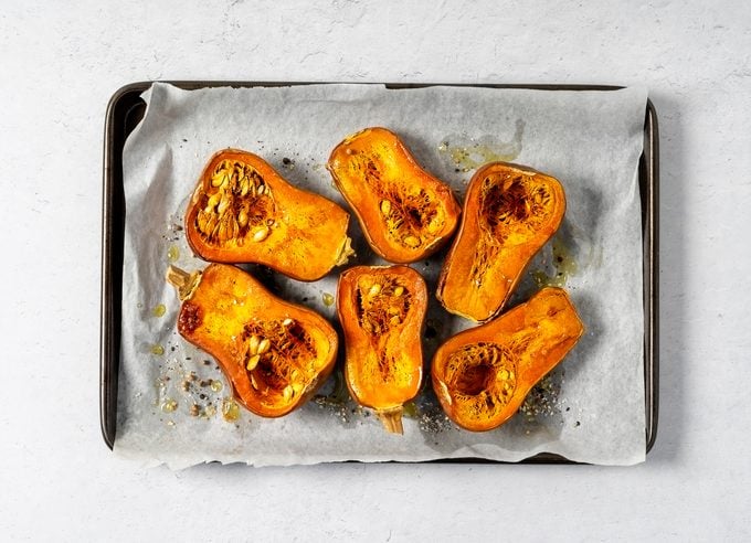 Tray of roasted butternut squash on white background