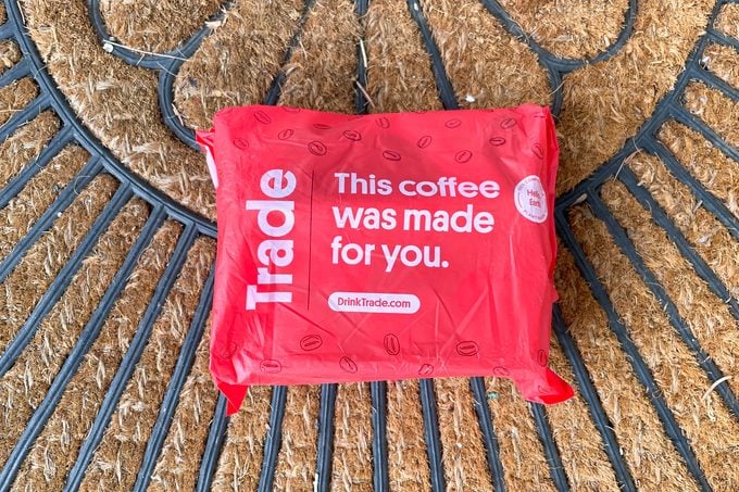 A box coved in a red bag placed on brown matt
