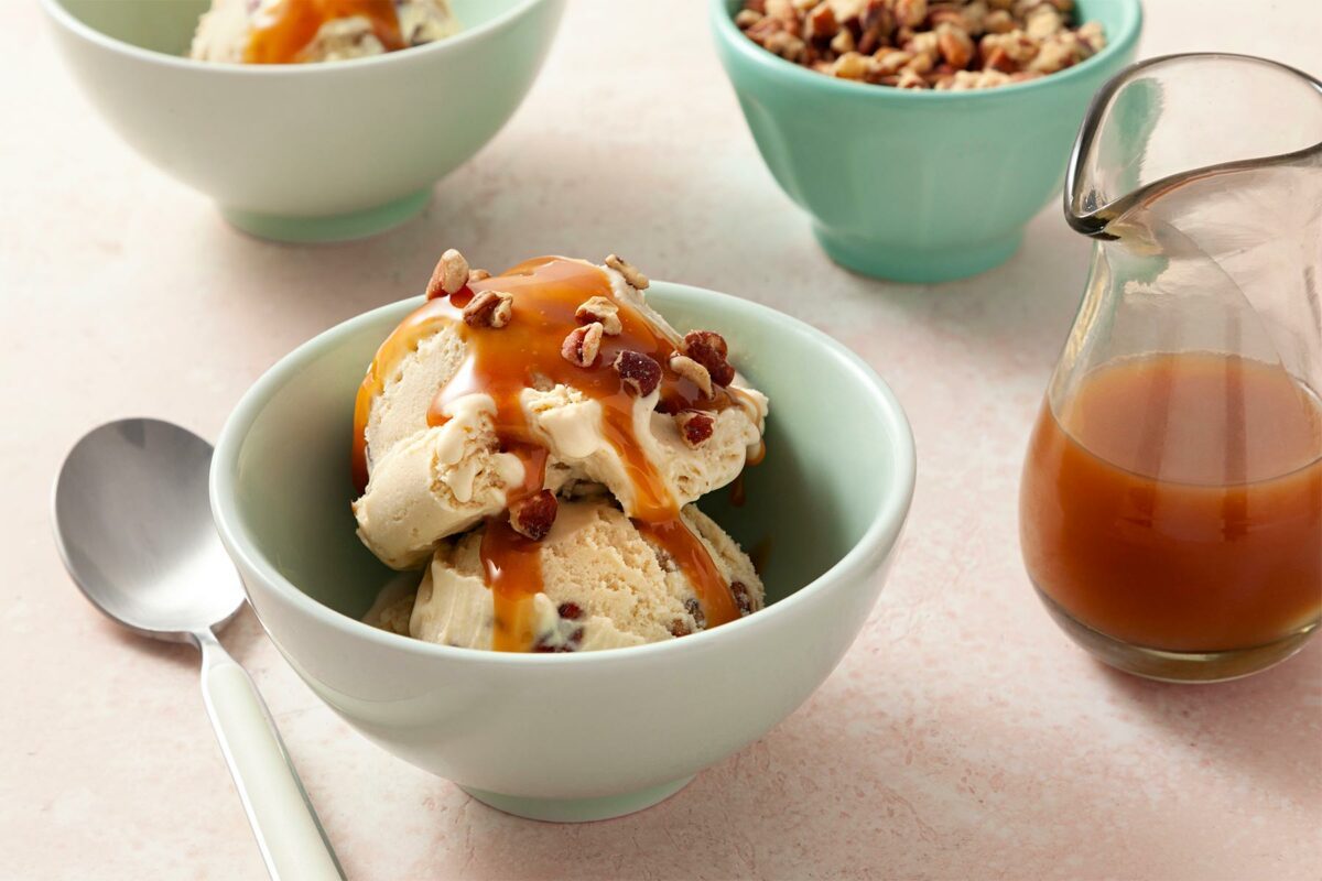 close shot of butter pecan ice cream with caramel sauce
