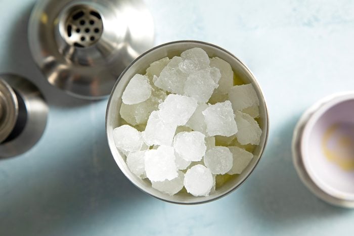 A cocktail shaker filled with ice cubes