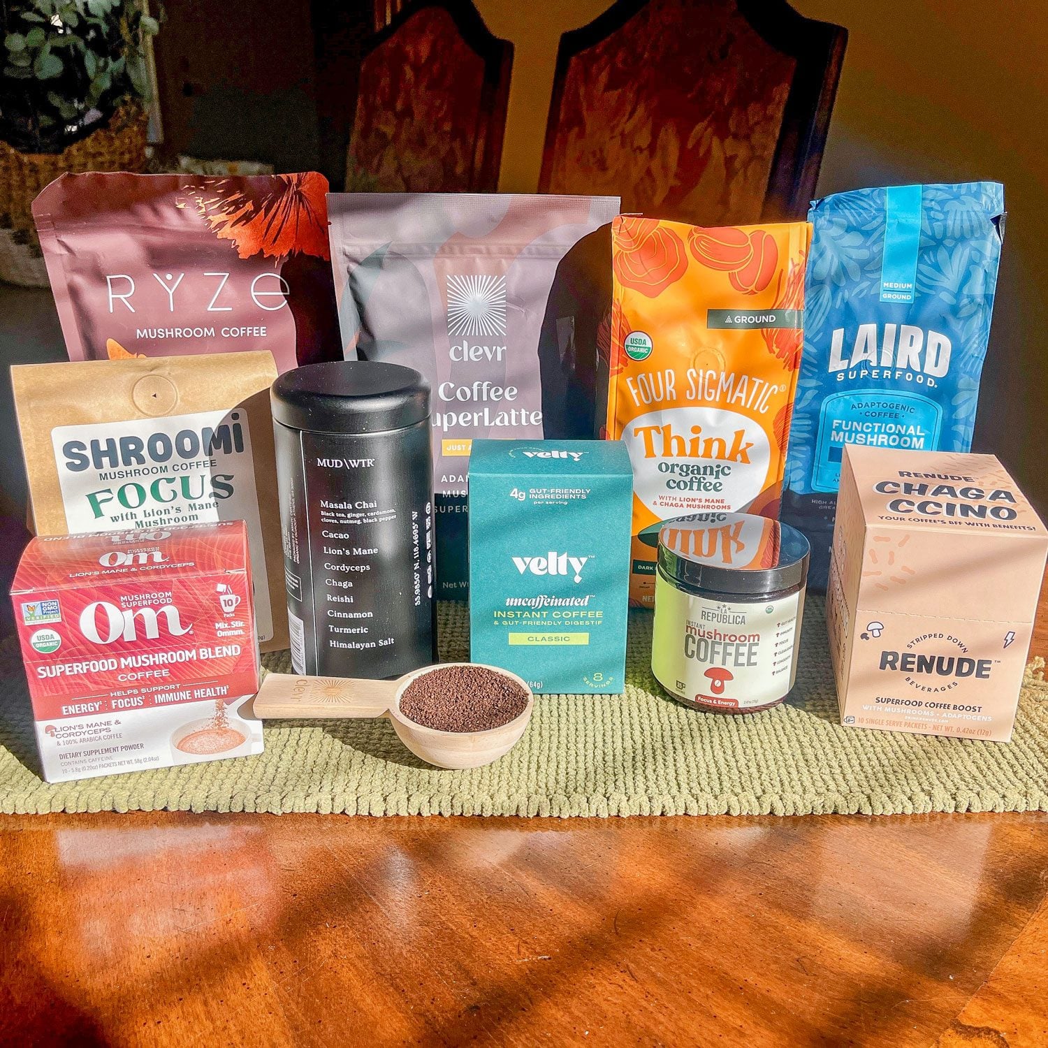 Variety of mushroom coffee products arranged together on a wood table