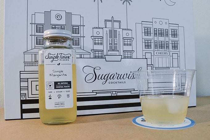 Sugarwish Cocktail Mixer with a glass and a jar on a table