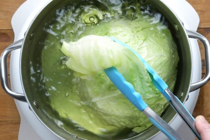 overhead shot of cabbage leaves in the boiling water
