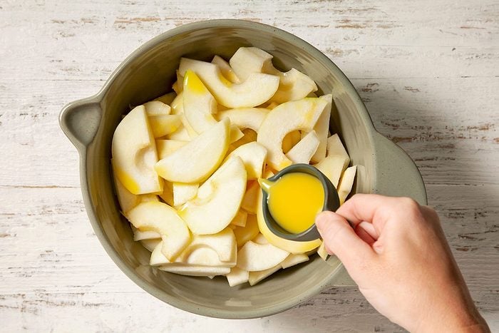 Toss the pears with orange juice and place them in a greased
