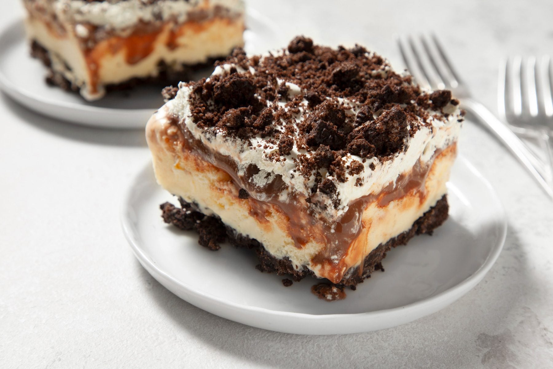 A piece of Oreo Ice Cream Cake served in a dessert plate