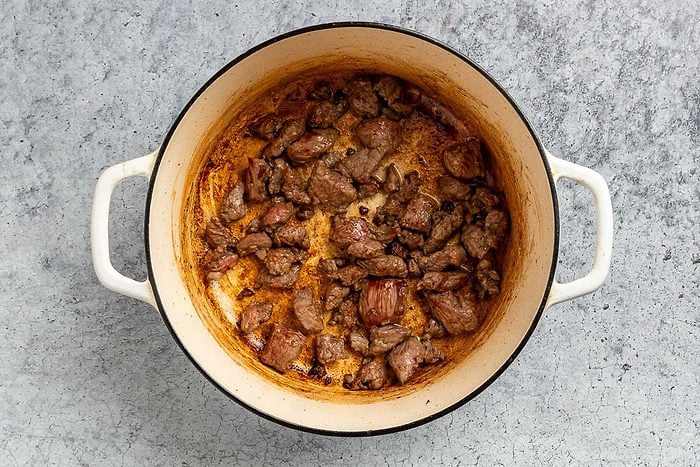 Taste of Home Beef Barley Stew recipe photo of the browned meat in a dutch oven.