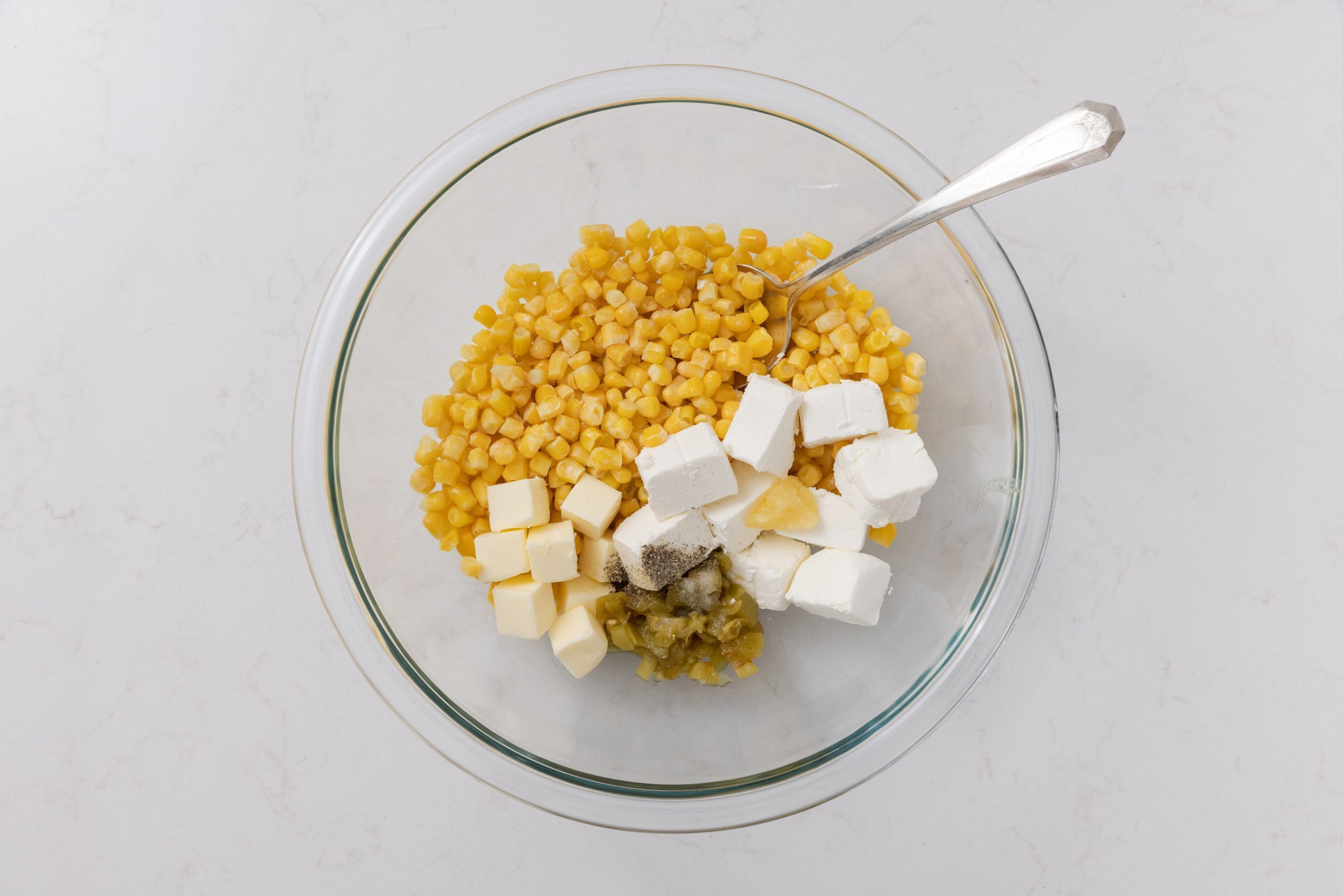 Casserole ingredients being mixed in a bowl.