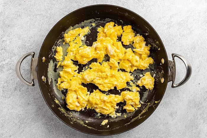 Taste of Home Ham Egg and Cheese Sandwich recipe photo of the cooked eggs in a skillet.