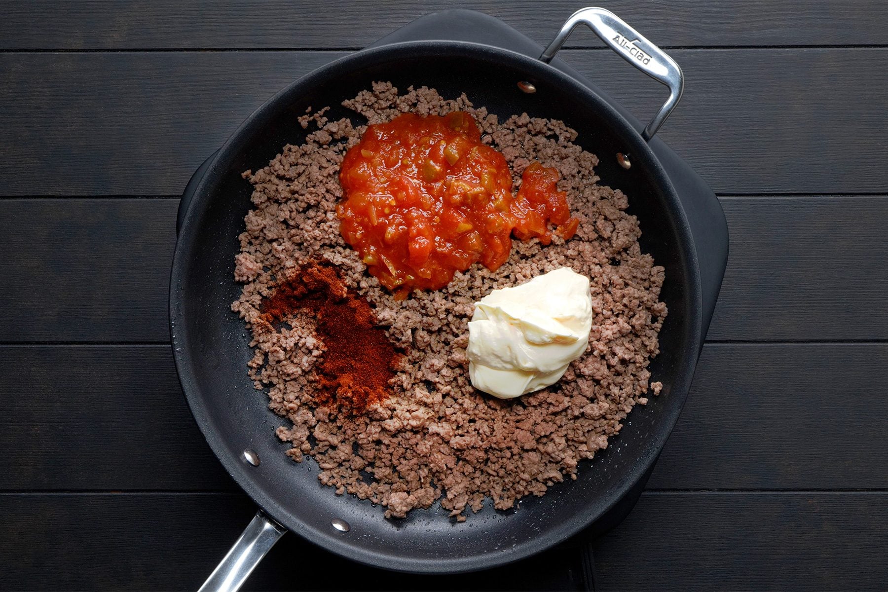 overhead shot; black background; Added the salsa, mayonnaise and chili powder in beef;