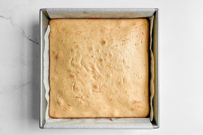 Taste of Home Peanut Butter Cake in a metal baking pan on a marble surface