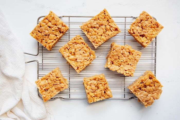 Overhead beauty shot for Taste of Home Peanut Butter Cornflake Cookies cut on a wire rack.