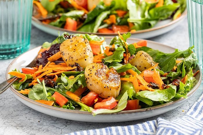 Taste of Home Scallop Salad photo of the finished recipe served on plates.