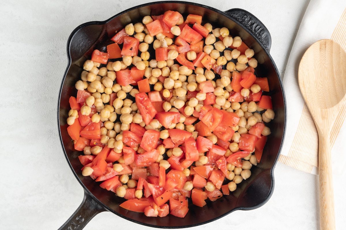Overhead landscape shot of tomatoes and chickpeas for Taste of Home's Spinach Tomato Pasta.