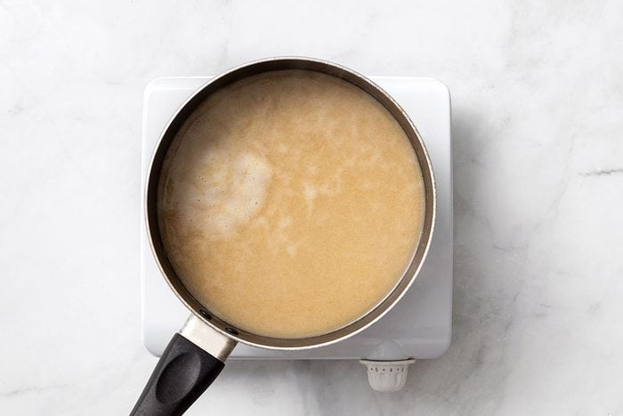 Chicken broth, cumin, garlic powder, salt and pepper in a saucepan