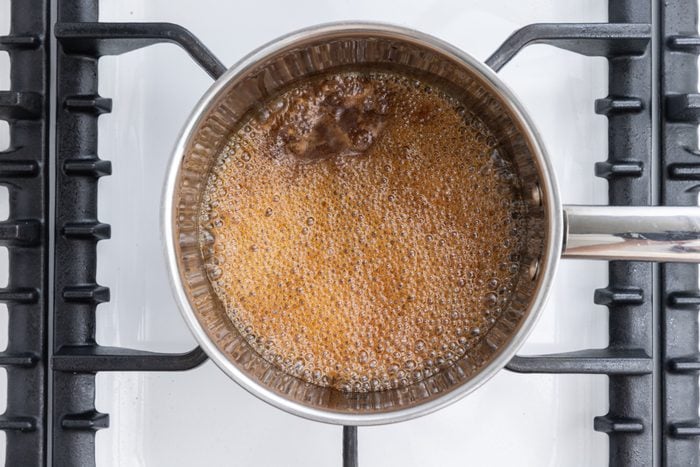 Juices being brought to a boil to make the sauce served with pork loin.