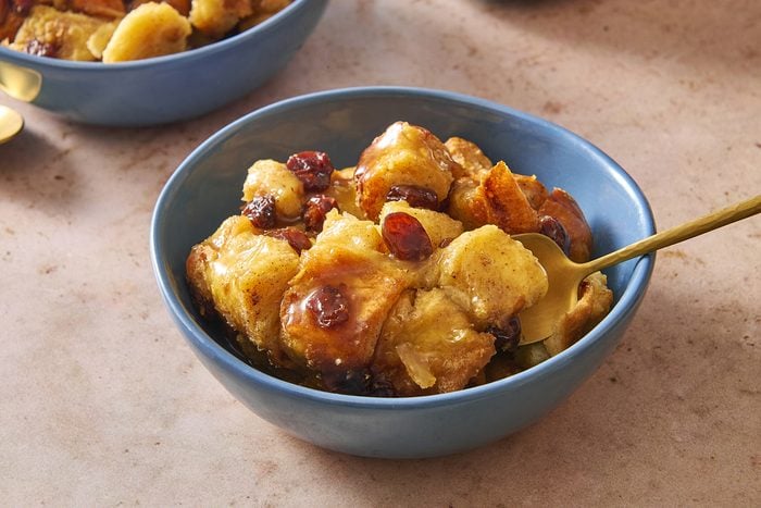 Closeup shot of a bowl of bread pudding with bourbon sauce