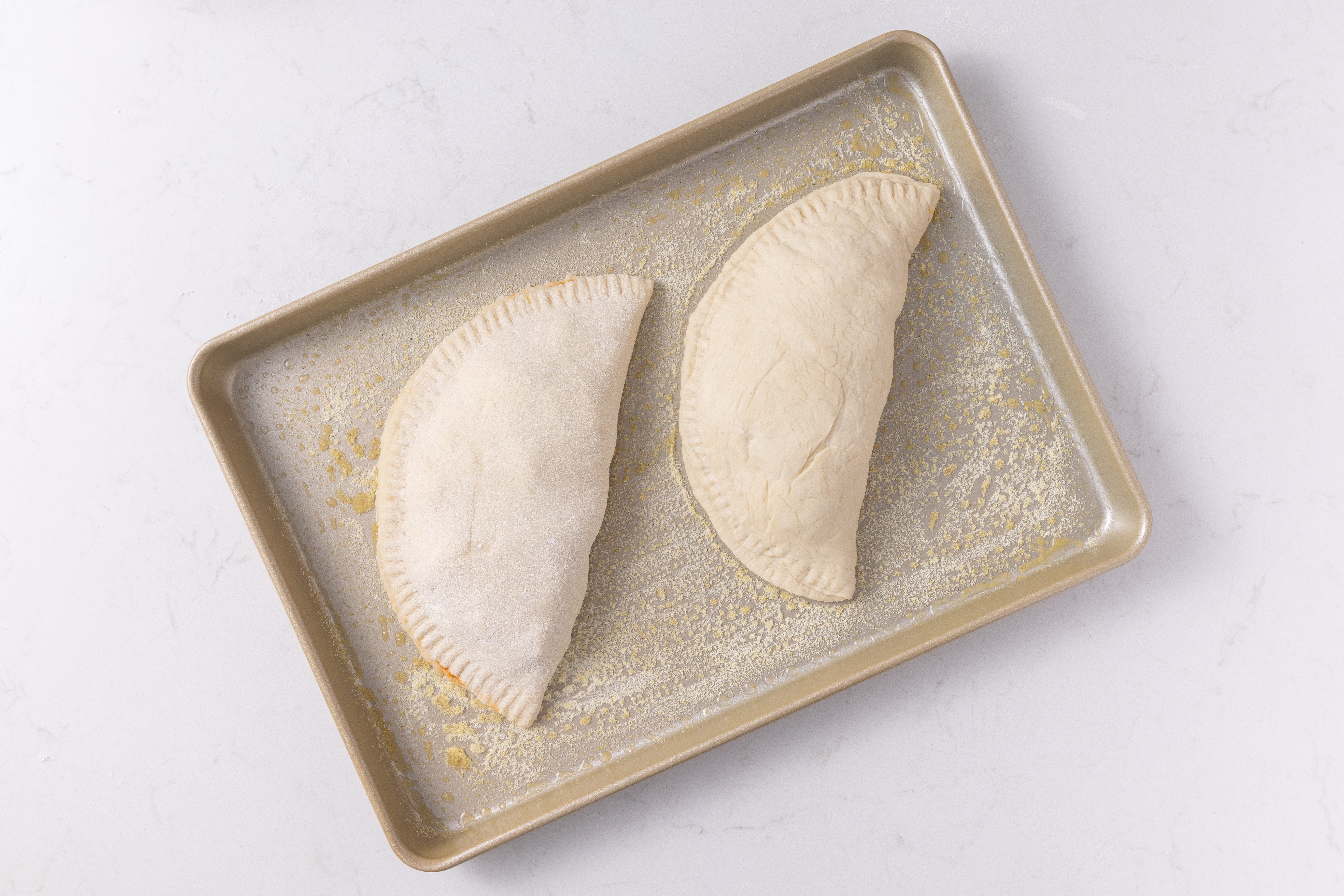 Calzones ready to go in the oven.