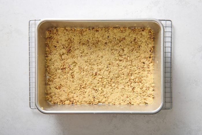 Baked crust in a pan cooling on a rack