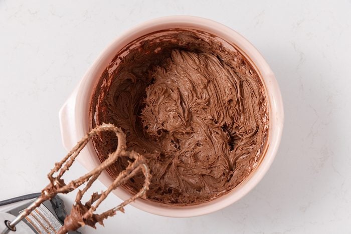 Frosting being prepared in mixing bowl.