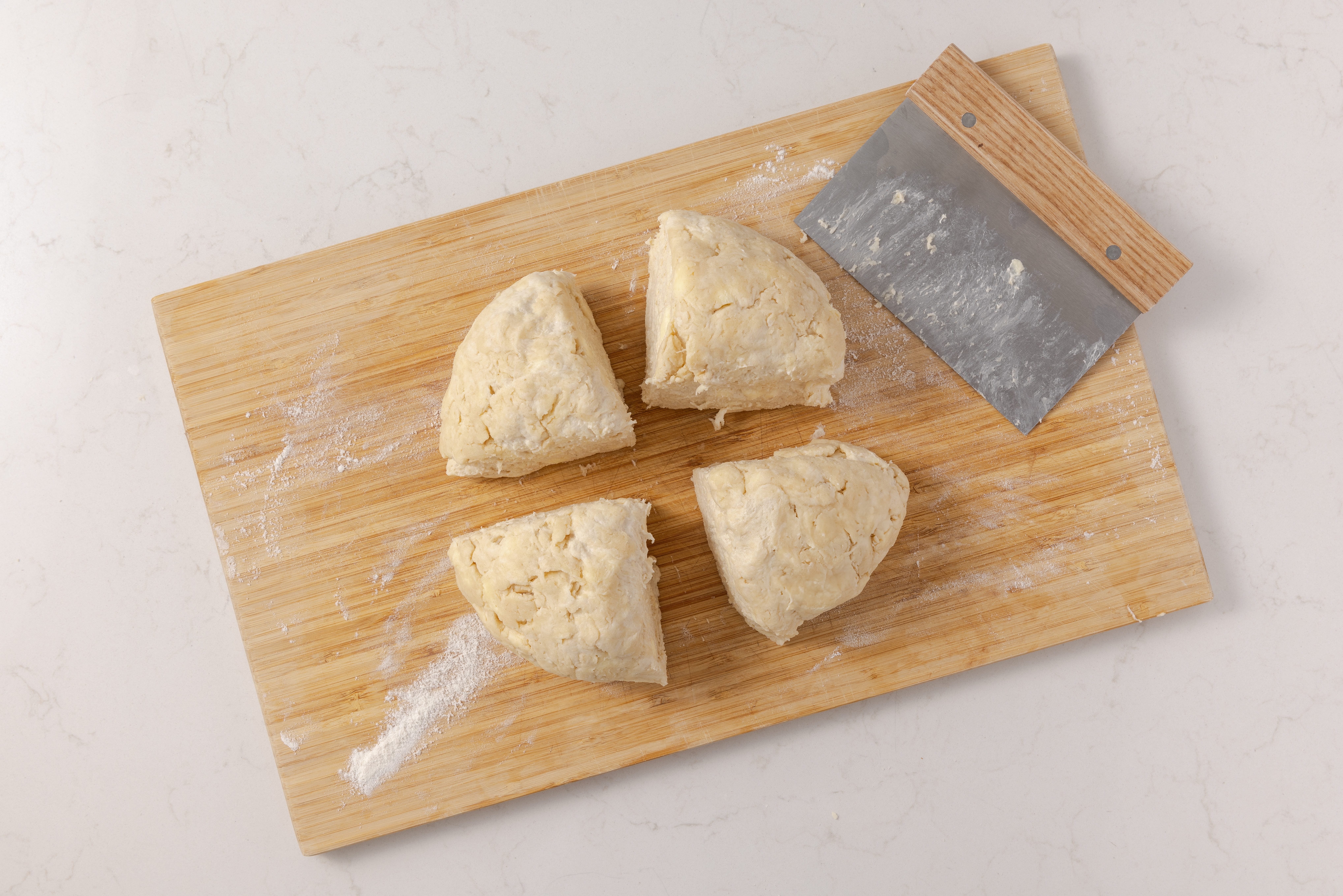Dough divided in four equal parts to be rolled and filled with almond paste mixture.