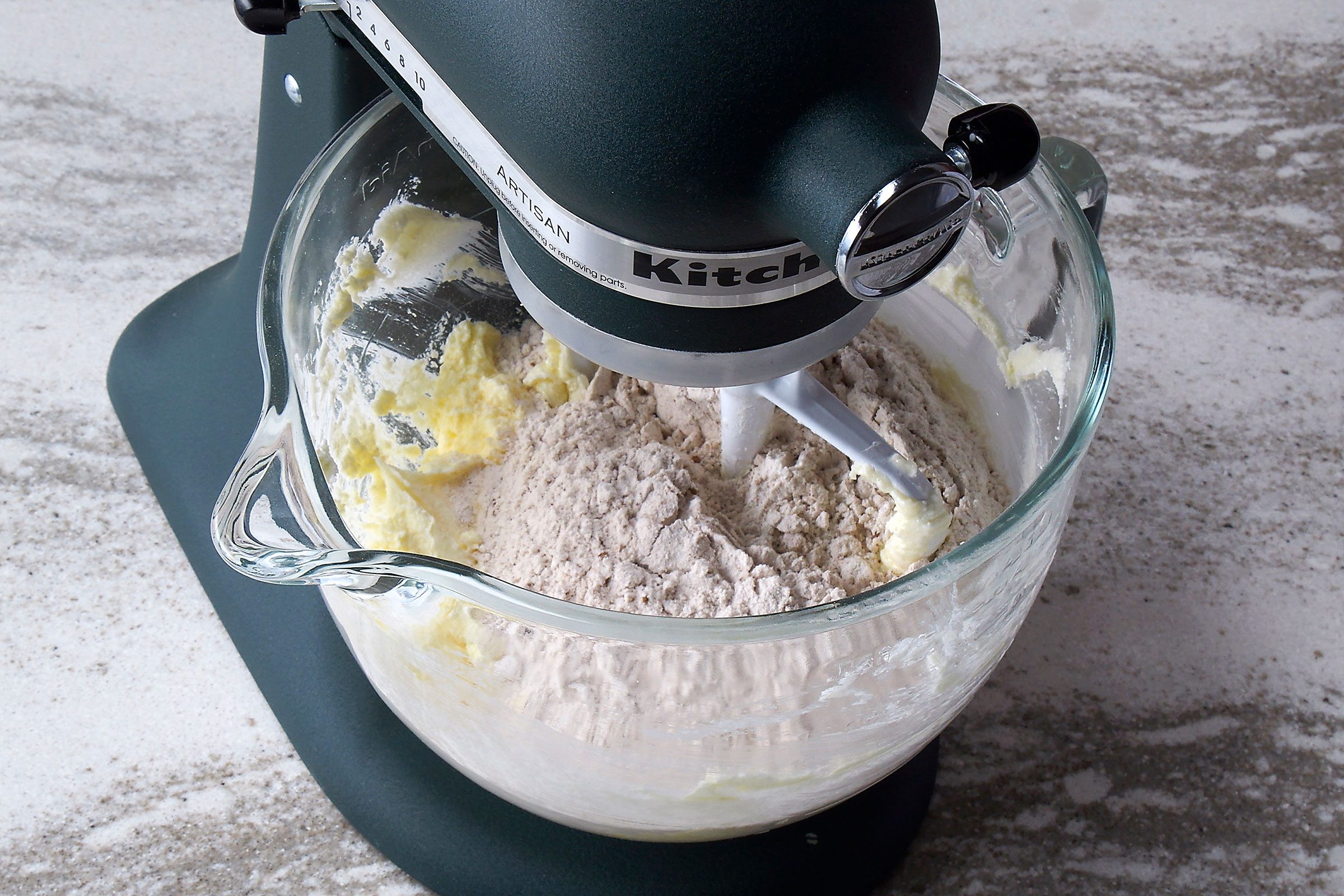 Dry cookie ingredients mixed with butter and sugar 