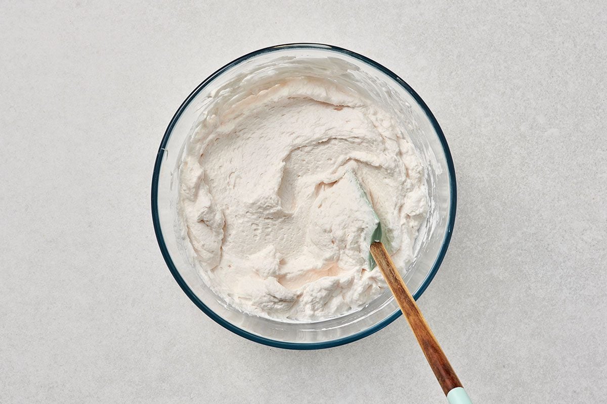 All ingredients combined in a bowl with a spatula