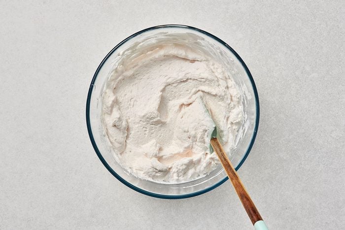All ingredients combined in a bowl with a spatula