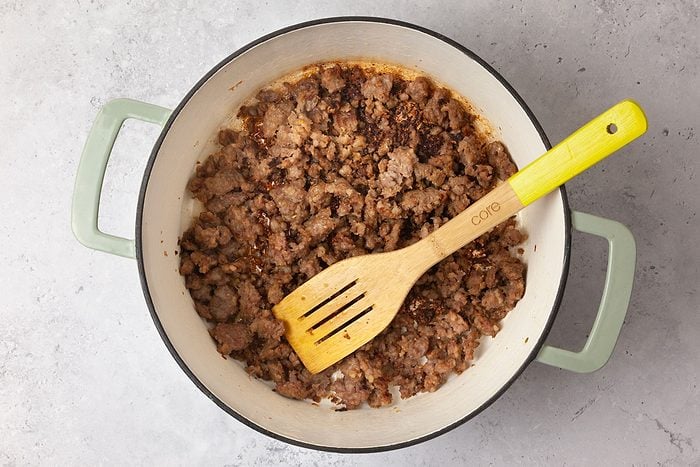 Step 2 of Taste of Home Pasta with Sausage & Peas is to brown the sausage and the garlic